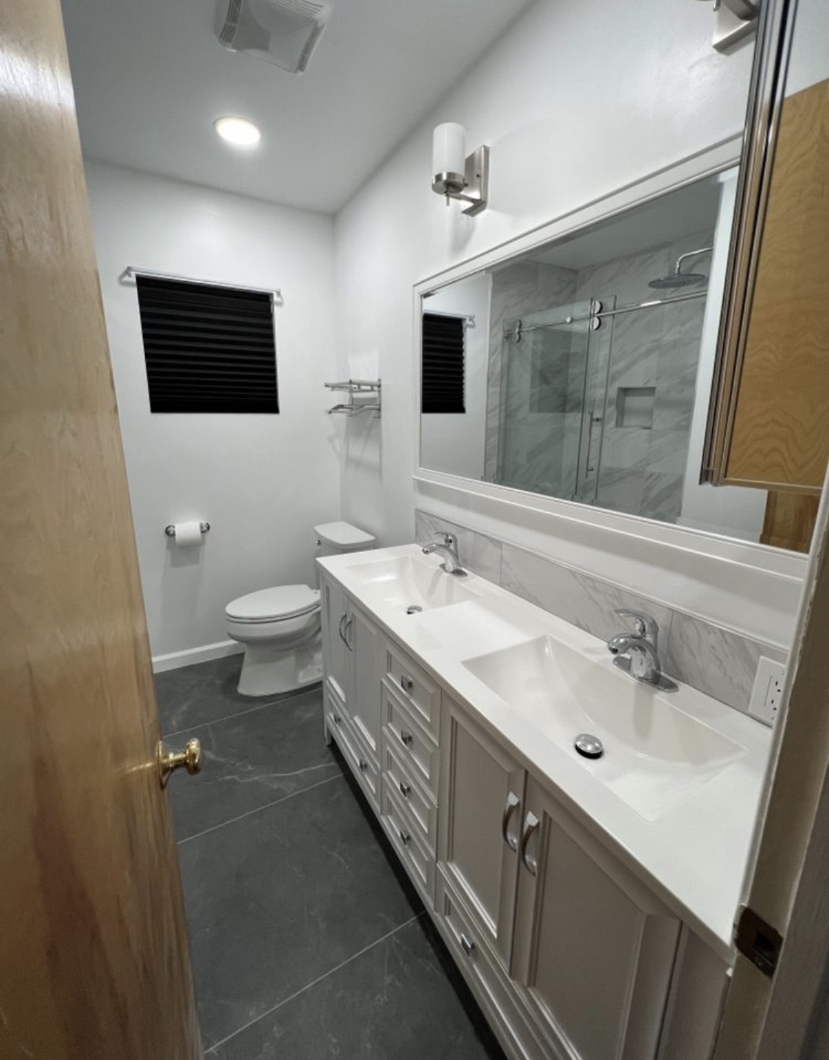 Double-vanity bathroom with marble backsplash