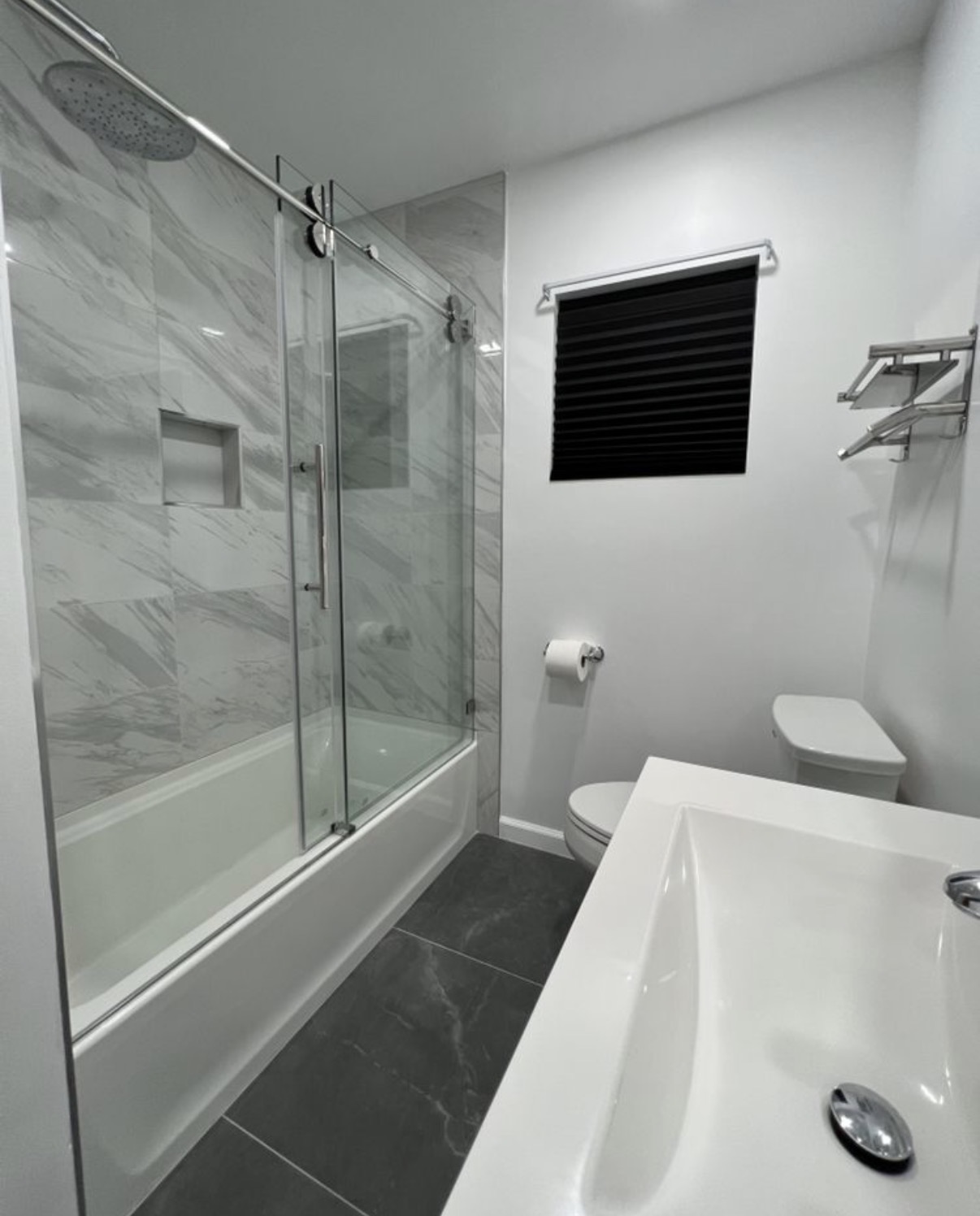 Marble tub-shower combo with sliding glass
