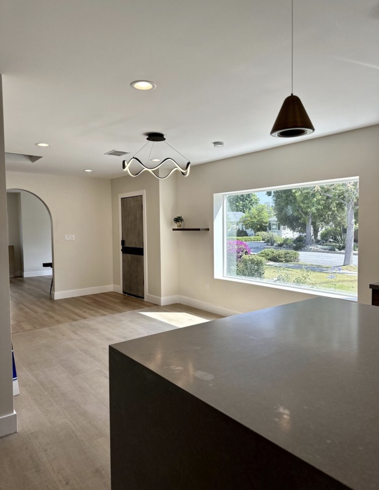 Open-concept entry with quartz island & picture window