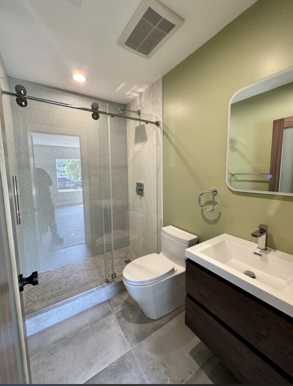 Modern guest bathroom with sliding glass shower