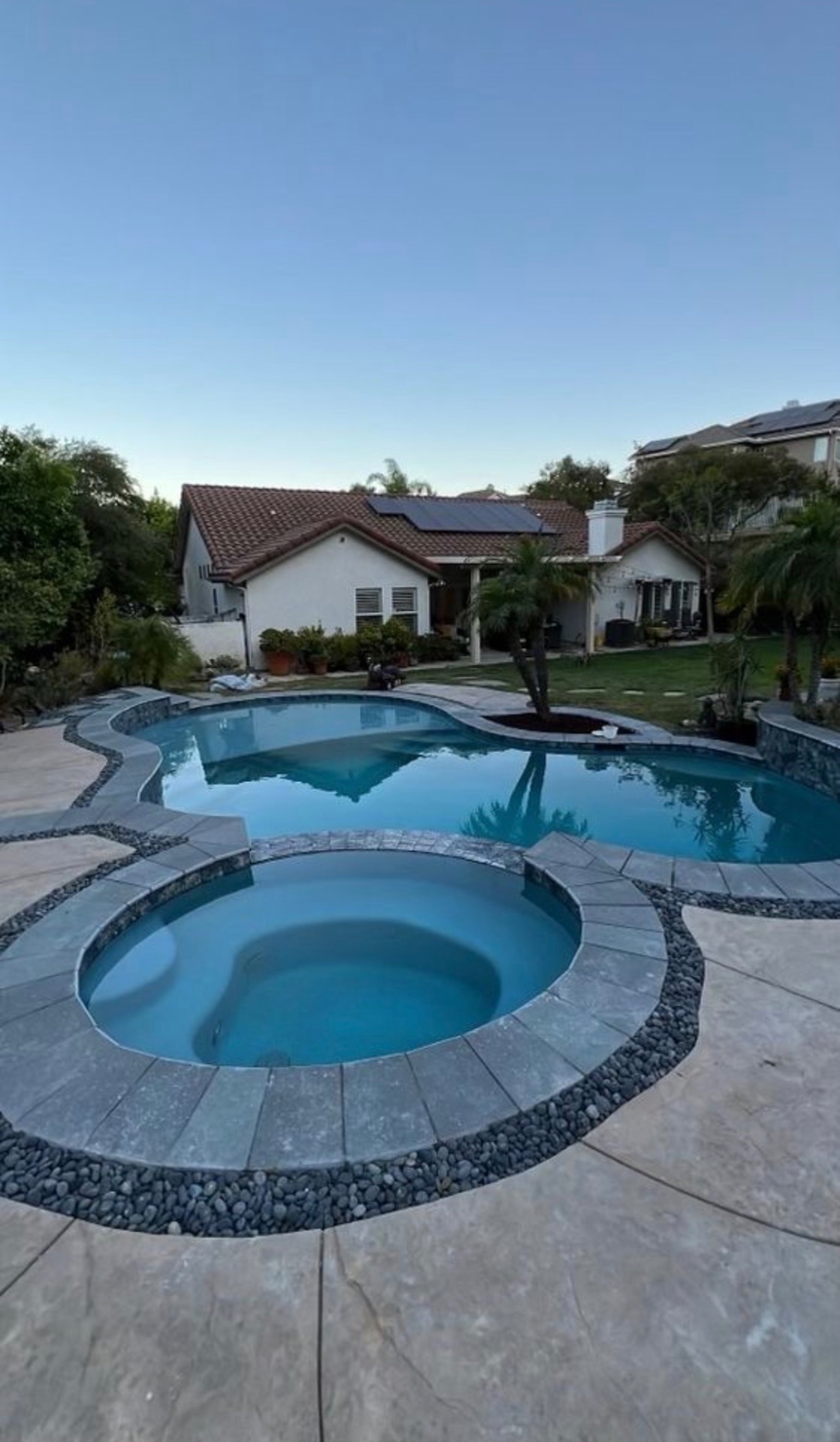 Custom backyard pool & spa with stone coping